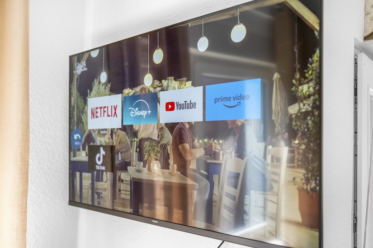 Fernseher an der Wand mit Startseite von Streamingdiensten